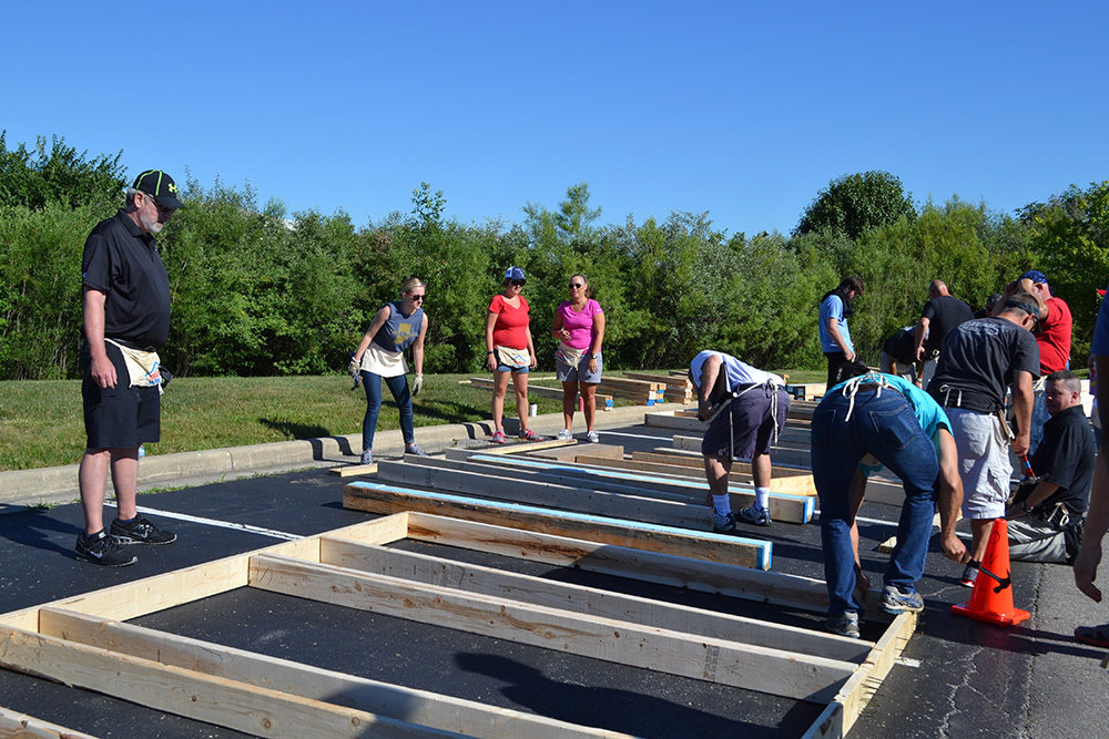OW employees work on wood paneling during Habitat for Humanity Build