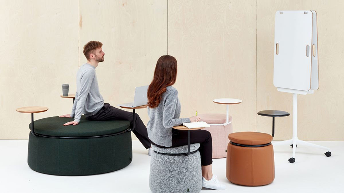 Staged photo of 2 people sitting on Naughtone Lasso Stools