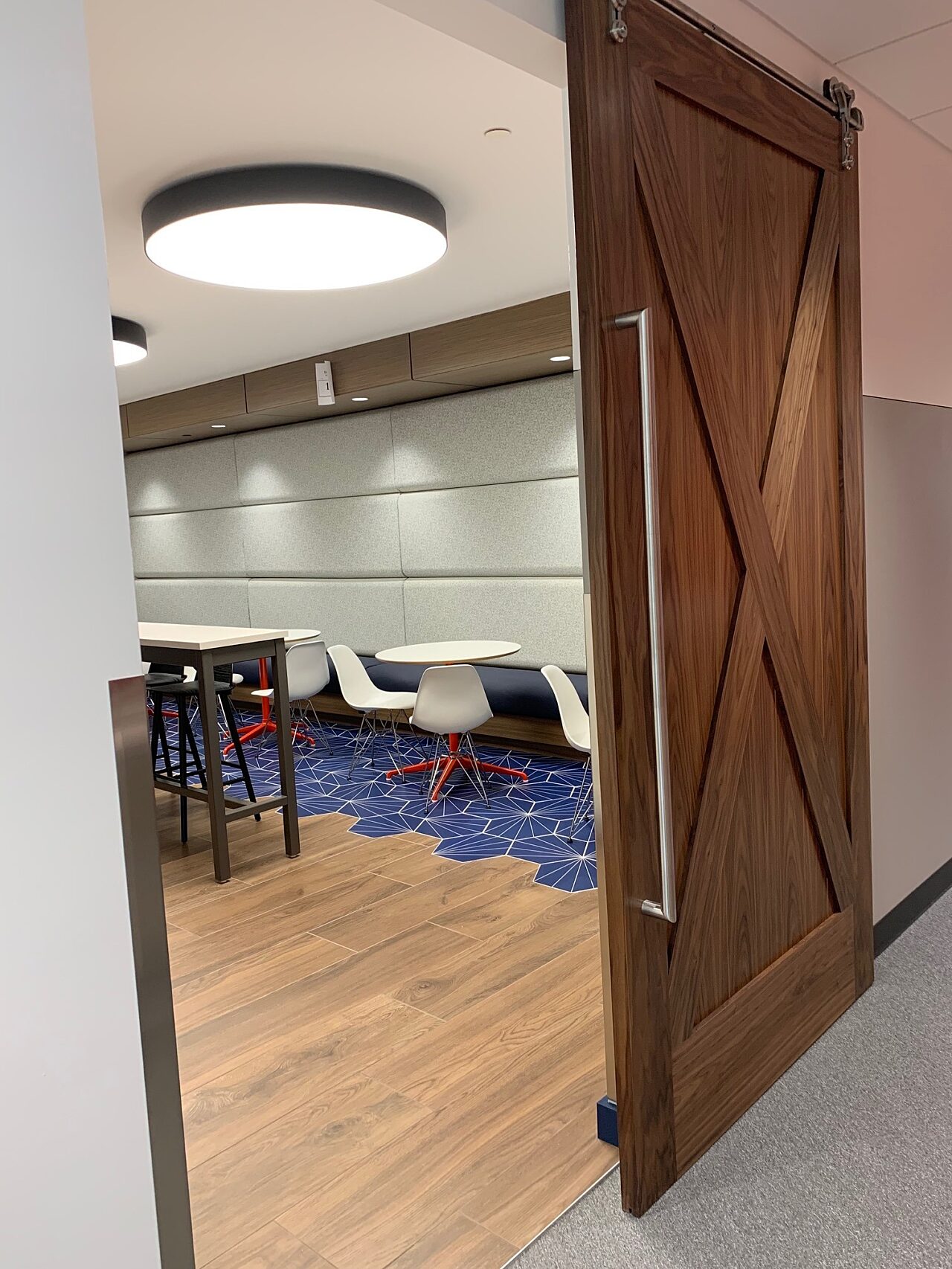 A sliding barn door opening into a dining area at the Goodman Campbell Brain and Spine center
