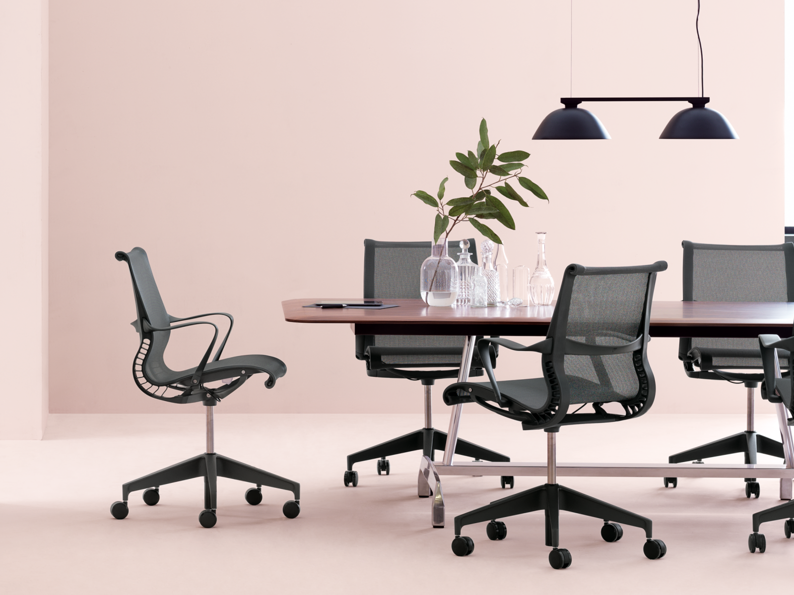 conference room with black chairs and pink walls