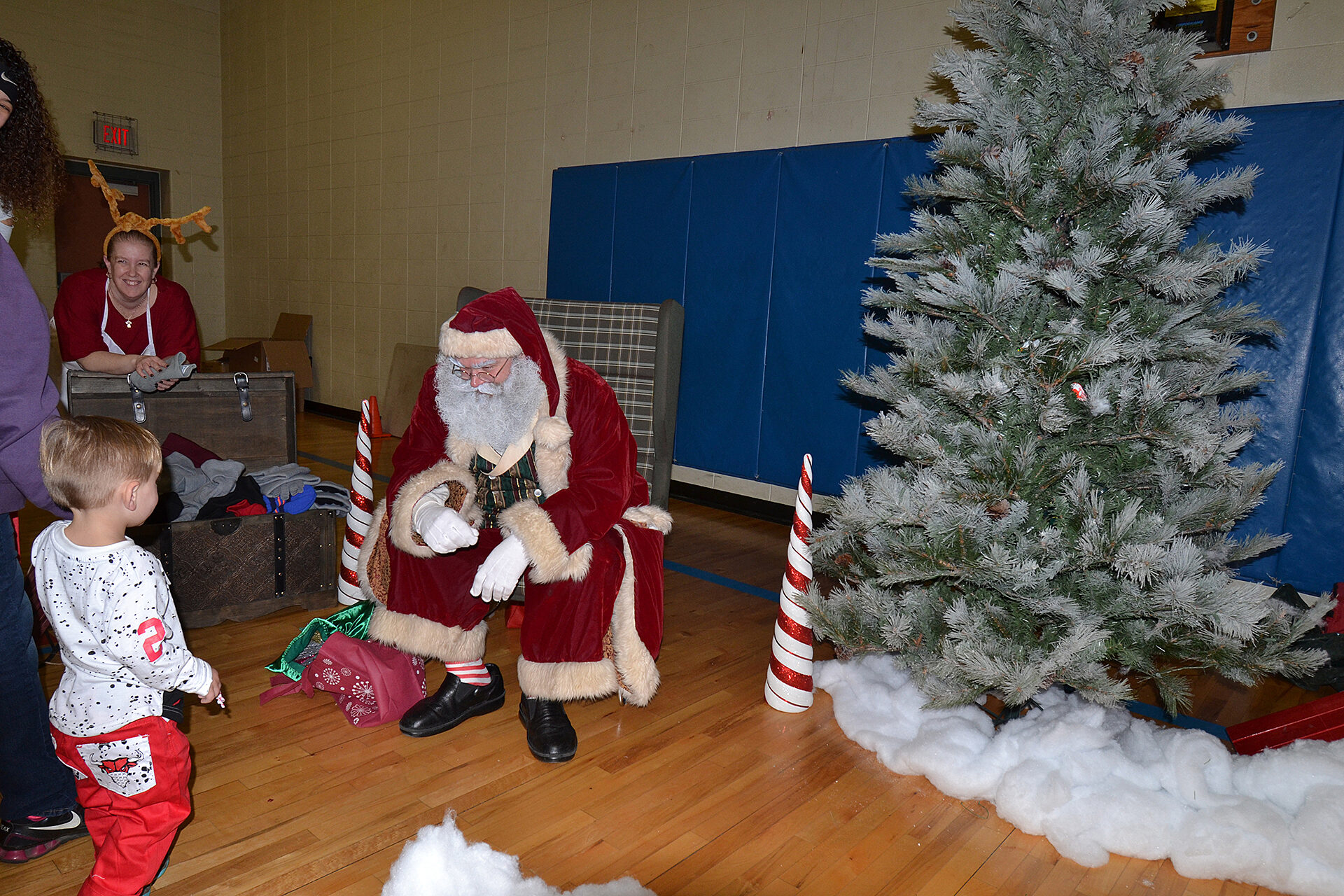 WeCare 2017: Santa by the tree talking to little boy