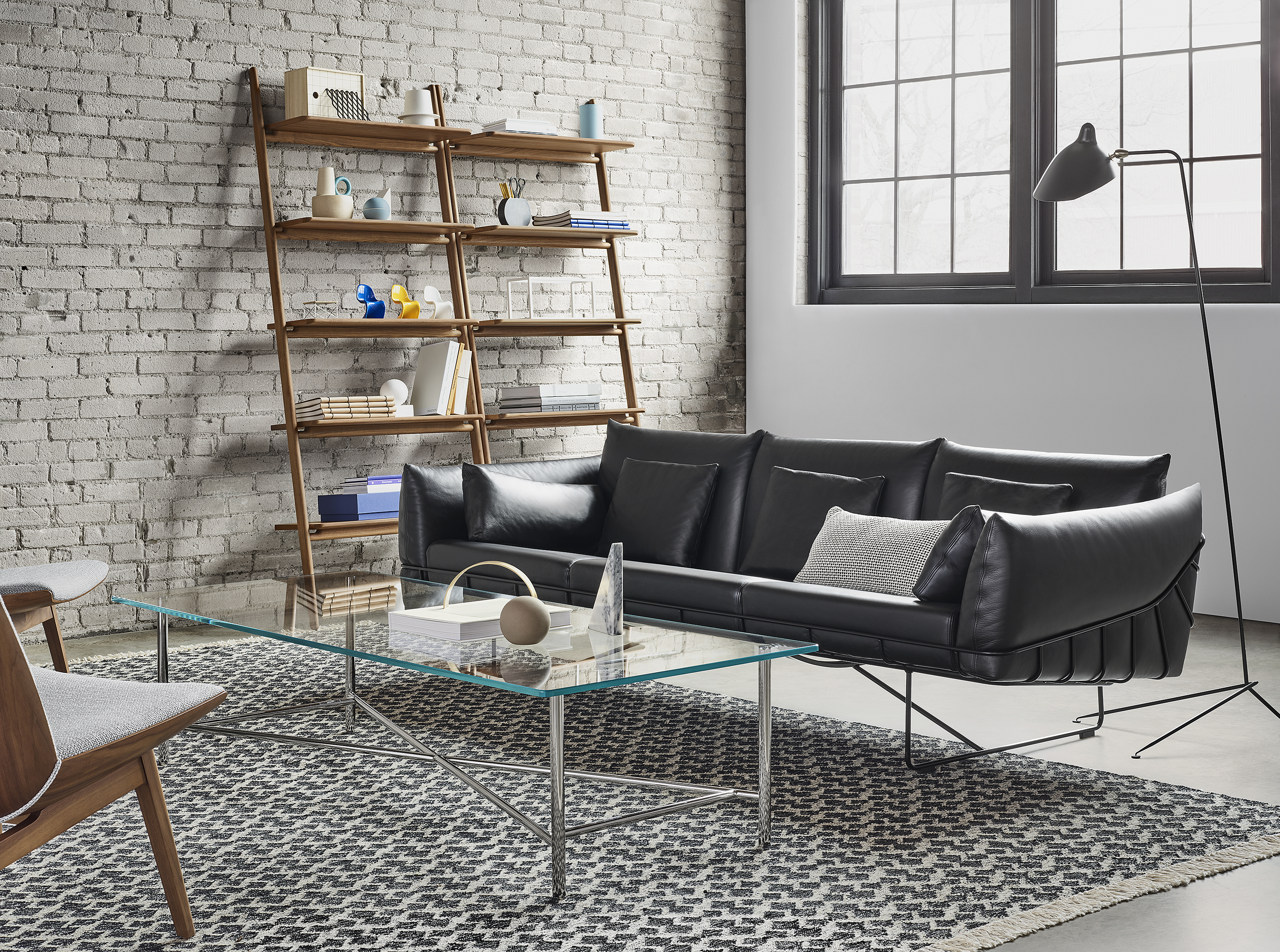 Design within reach couch with coffee table and storage product in background