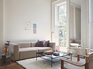 HAY tan sofa with coffee table and chairs