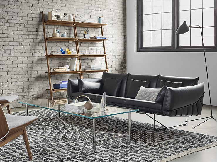 Design within reach couch with coffee table and storage product in background