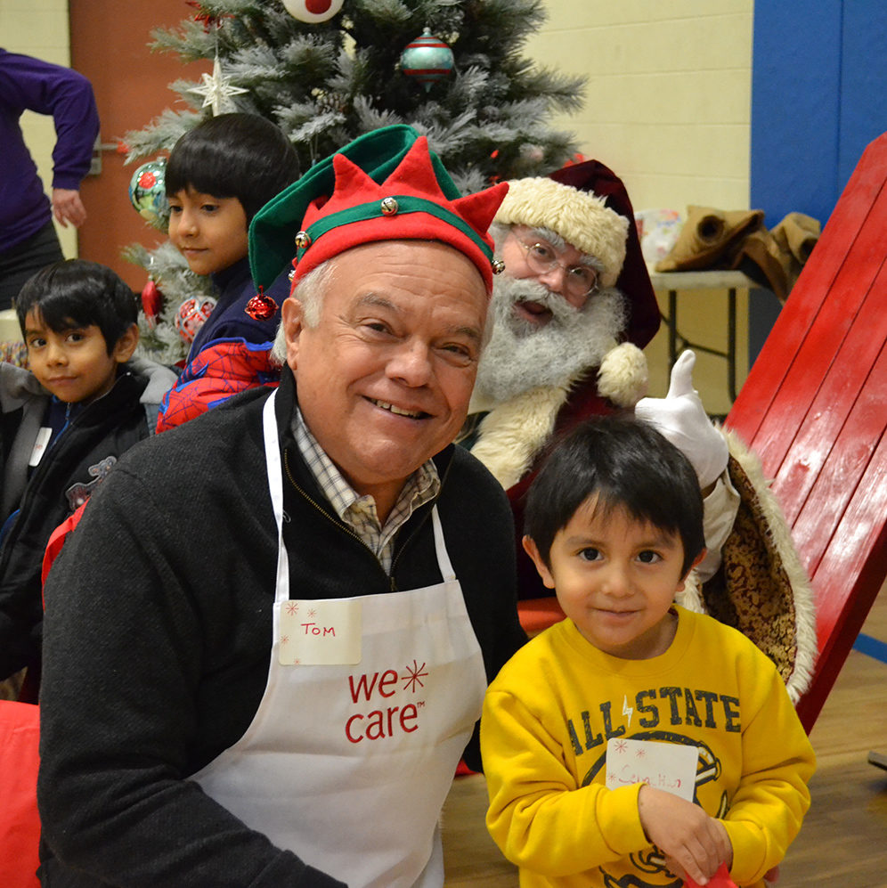 Tom, child and Santa at WeCare Christmas event
